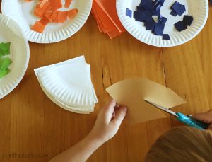 Step 3 of Thanksgiving Pie Garland for Kids: Cut out a triangle of brown construction paper and then cut off the edge to make it as a crust.