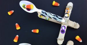 The perfect Halloween STEM activity is a Candy Corn Catapult! Even better? Try launching the candy corn, eyeballs and mini-pumpkins into cauldron targets!