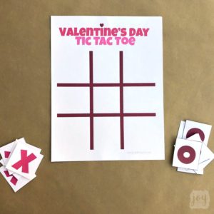 Need a quick and easy printable Valentine's Day Party Game? Valentine Themed Tic Tac Toe is always a hit, especially when you pair it with chocolate kisses or candy hearts! Download the free printable Valentine's Day game complete with game pieces or get inspired by the numerous creative game piece ideas! #valentinesdayparty #valentinesdaypartygames #kidgames #printablegame #freeprintable #tictactoe